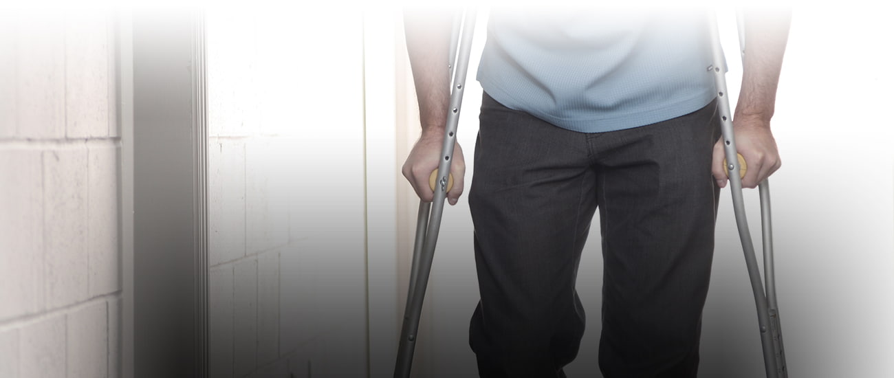 a man walking on crutches