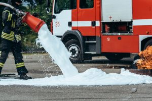 Firefighter using AFFF foam